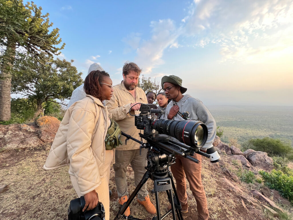 A filmmaker instructs students on how to use cinematography equipment in KwaZulu-Natal, South Africa, as part of the Africa Refocused program.